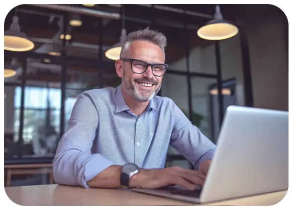 Man Smiling at Laptop